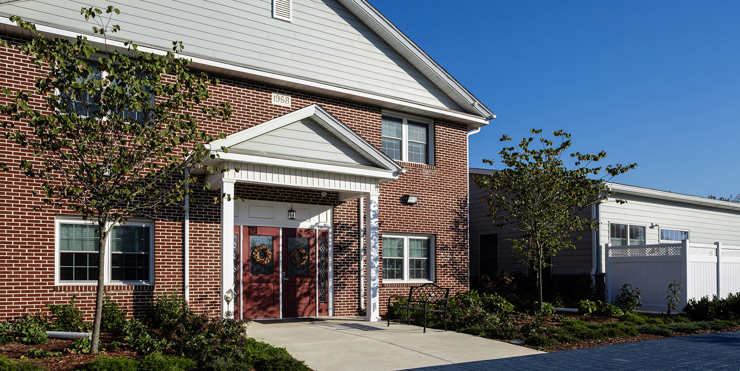 The front of Pappus house with red bricks and a large double door entry.